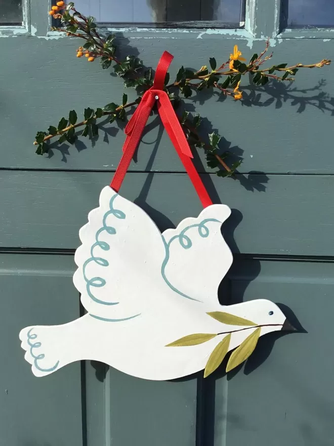 Dove hanging on a green door