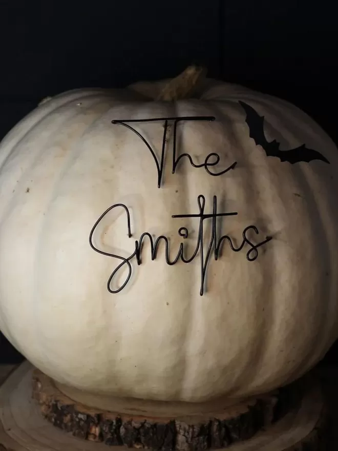 The smiths family name seen in a white pumpkin.