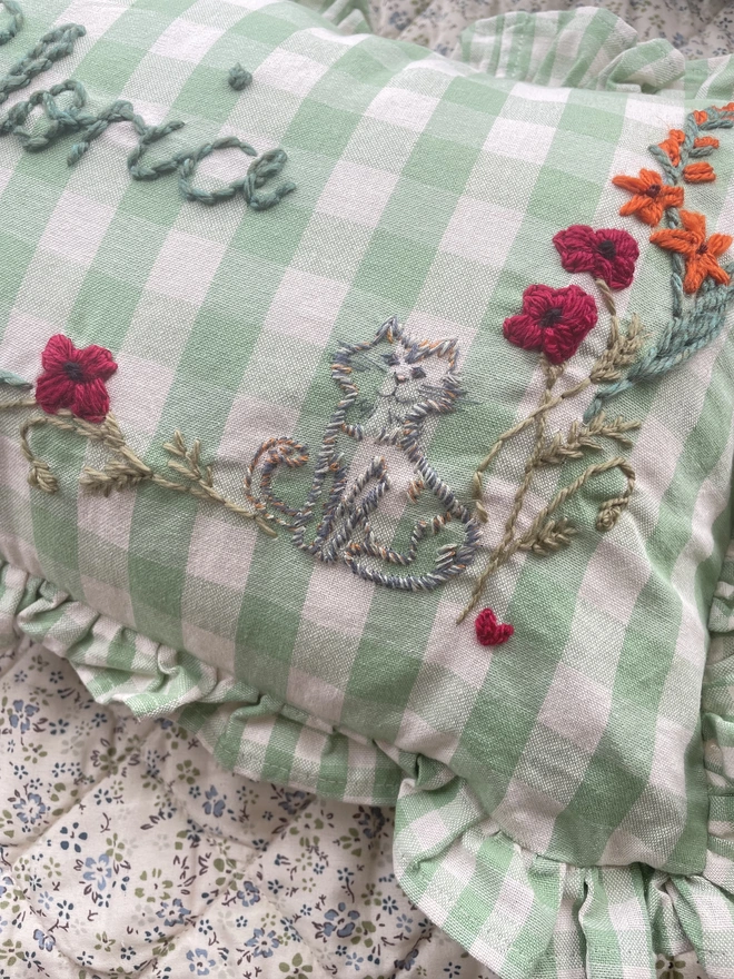 Hand embroidered cat with flower design