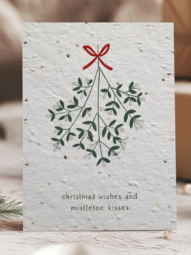 Christmas Card with illustration of mistletoe with 'Christmas Wishes and Mistletoe Kisses'