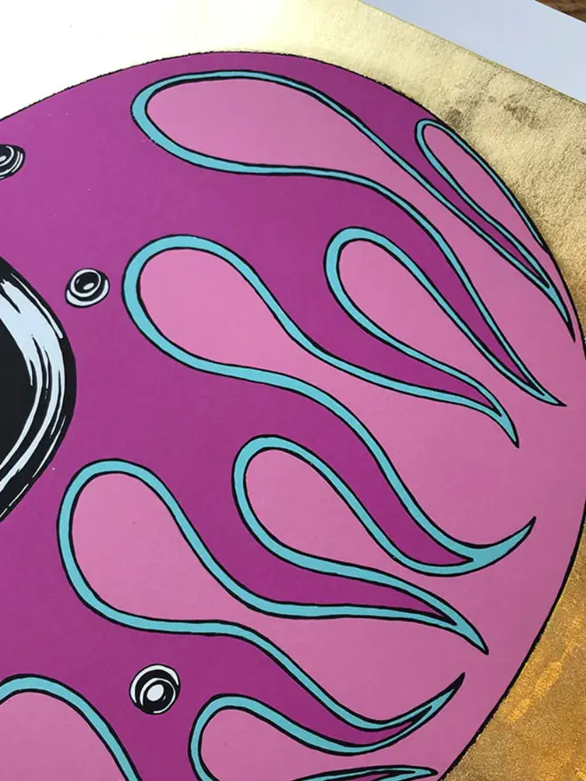 Motor cycle helmet with  a flame design on a gold background.