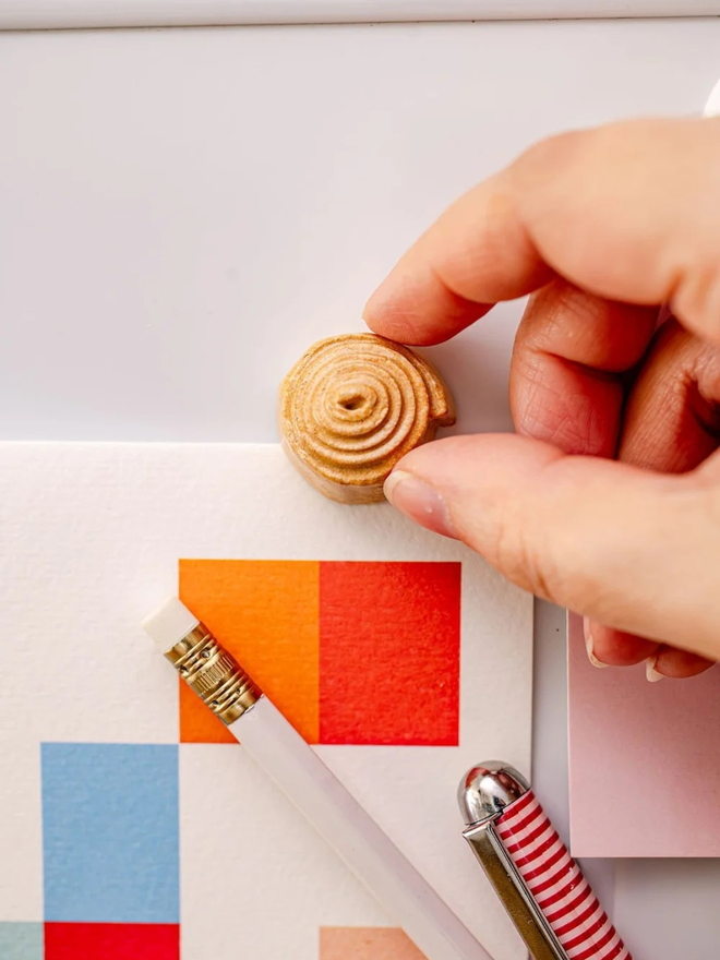 ceramic pastry magnets. a ceramic cinnamon bun magnet on a fridge door.