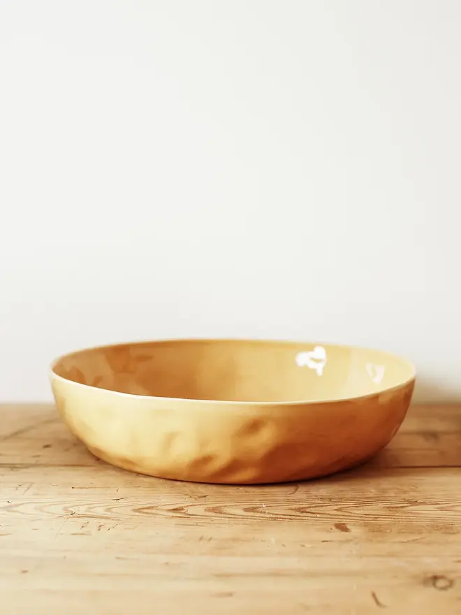 'dijon' handcrafted stoneware serving bowls. a large yellow serving bowl.