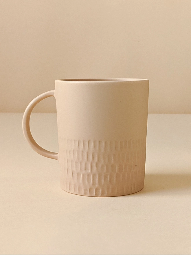 Large Morning Tea Mug made of porcelain in a Neutral Pale Oat with hand carved scalloped texture.