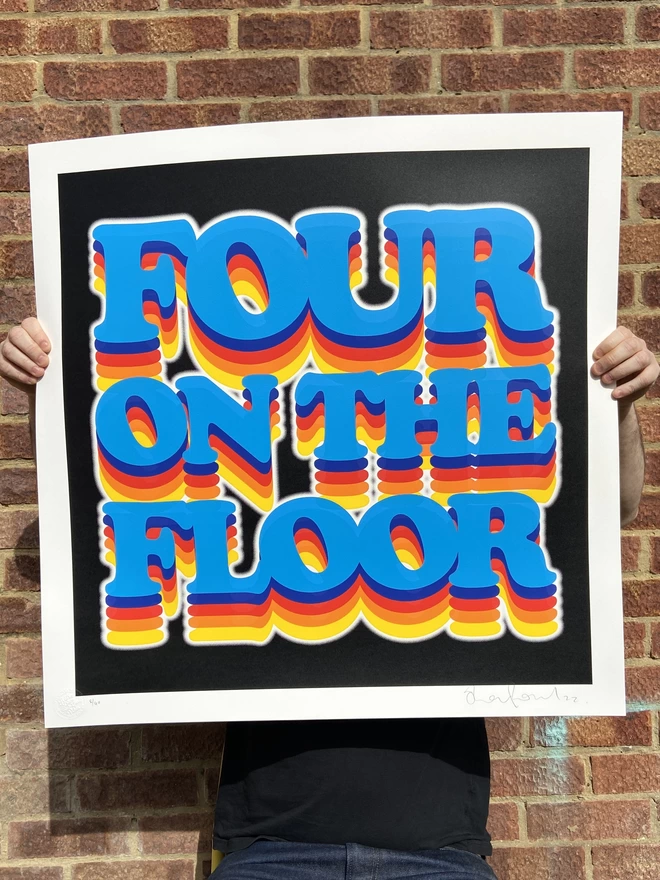 large square hand made screen print with the words “four on the floor”with rainbow letters and black background