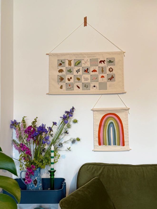 Cotton Pastel Mini Rainbow Fabric Banner, against a white wall. With Woodland Alphabet Banner.