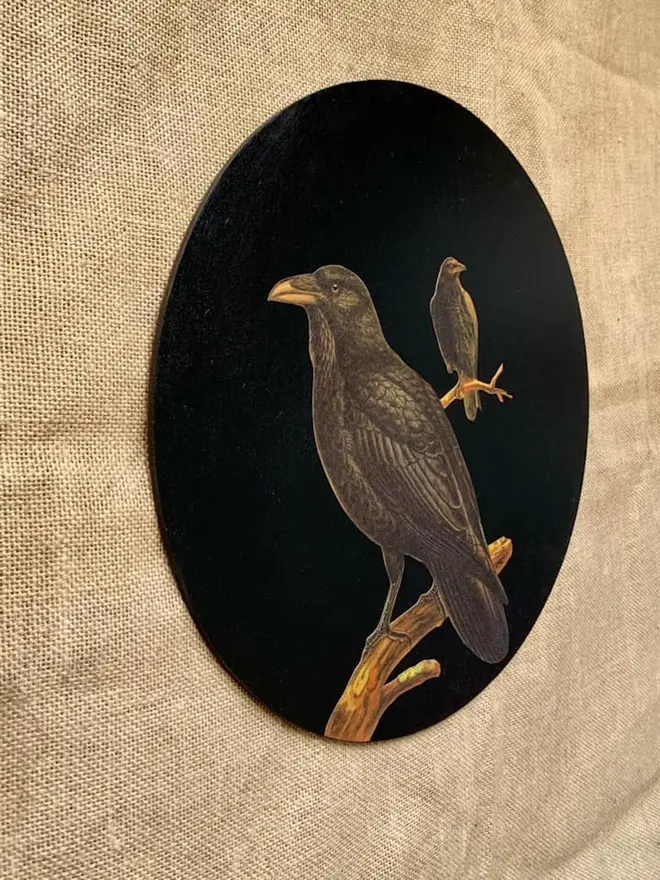 Round, black wall art with crows