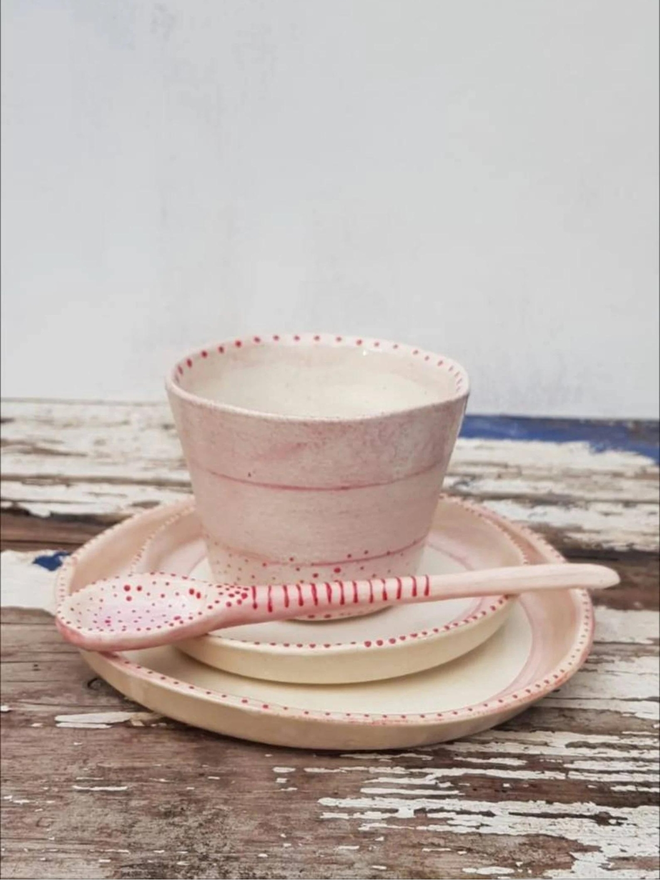 pink ceramic cup and saucers