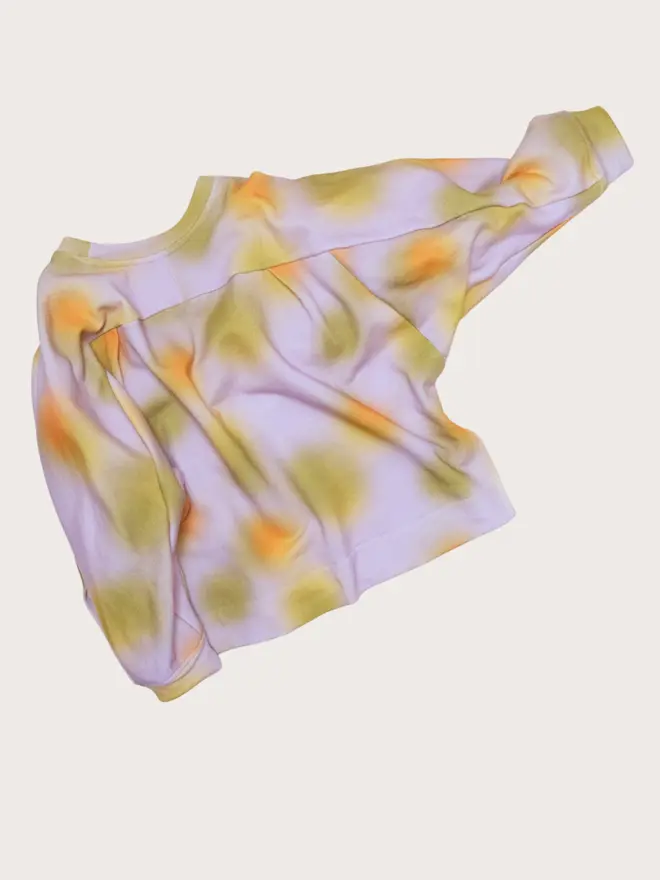Back flat lay of the Studio Koter Riverson top in Hazy Lilac, showing the yoke seam and ribbed hem.