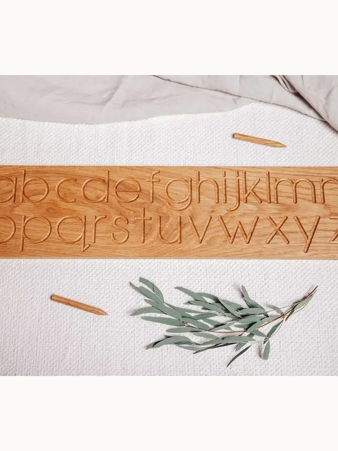 Wooden Alphabet Tracing Board Heirloom Toy, on a table. 