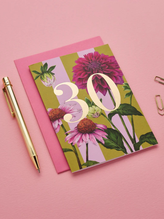 floral age milestone card. a pink floral 30th birthday card photographed against a pink background.
