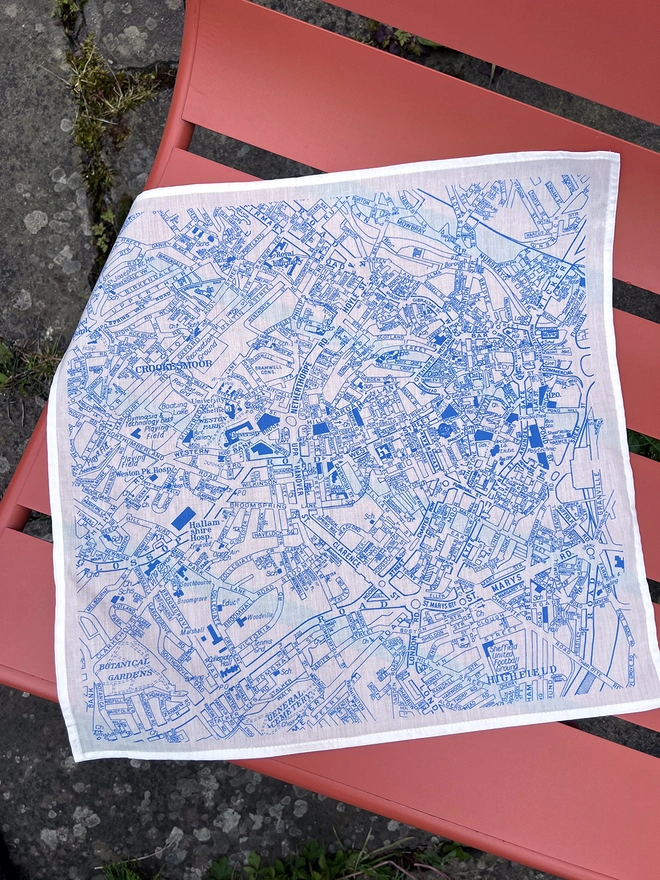 A Mr.PS Sheffield Handkerchief laid out an orange outdoor chair