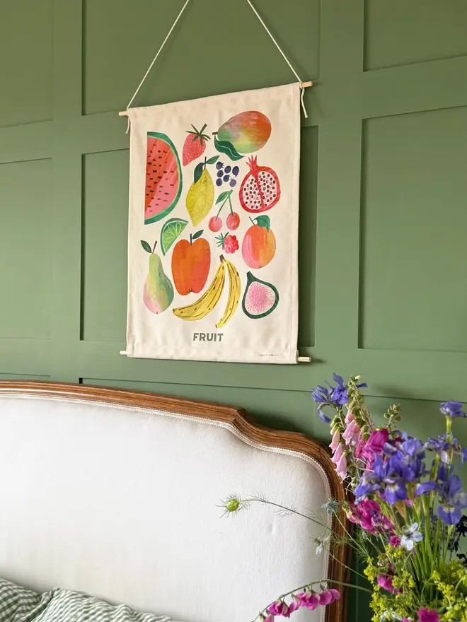Fruit Print Fabric Banner, hanging on a green wall. 