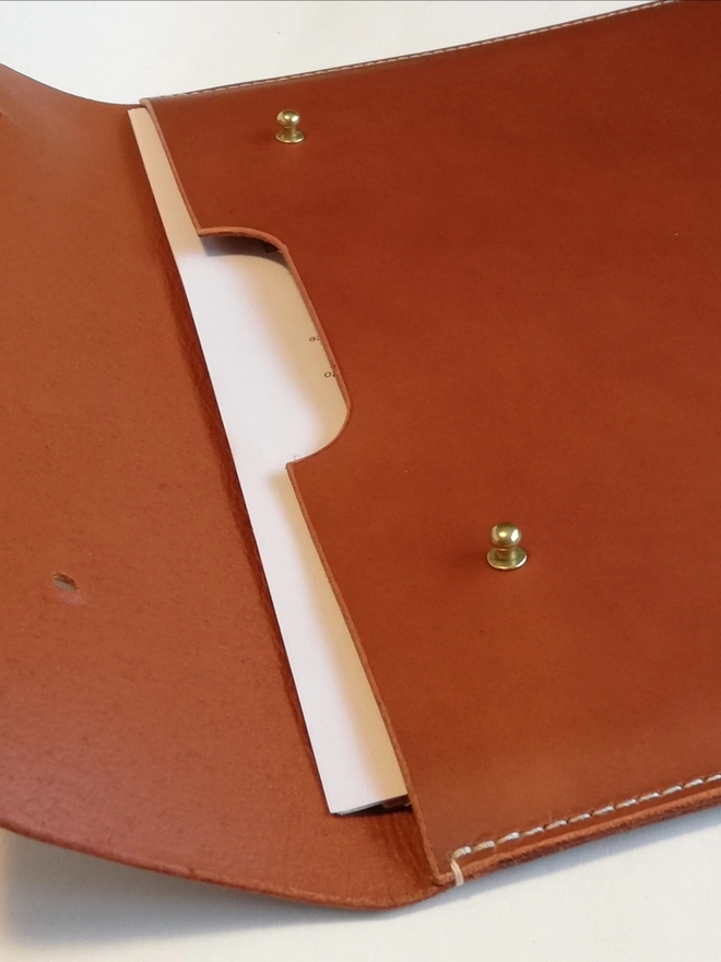 brown leather document case with graduation certificates 