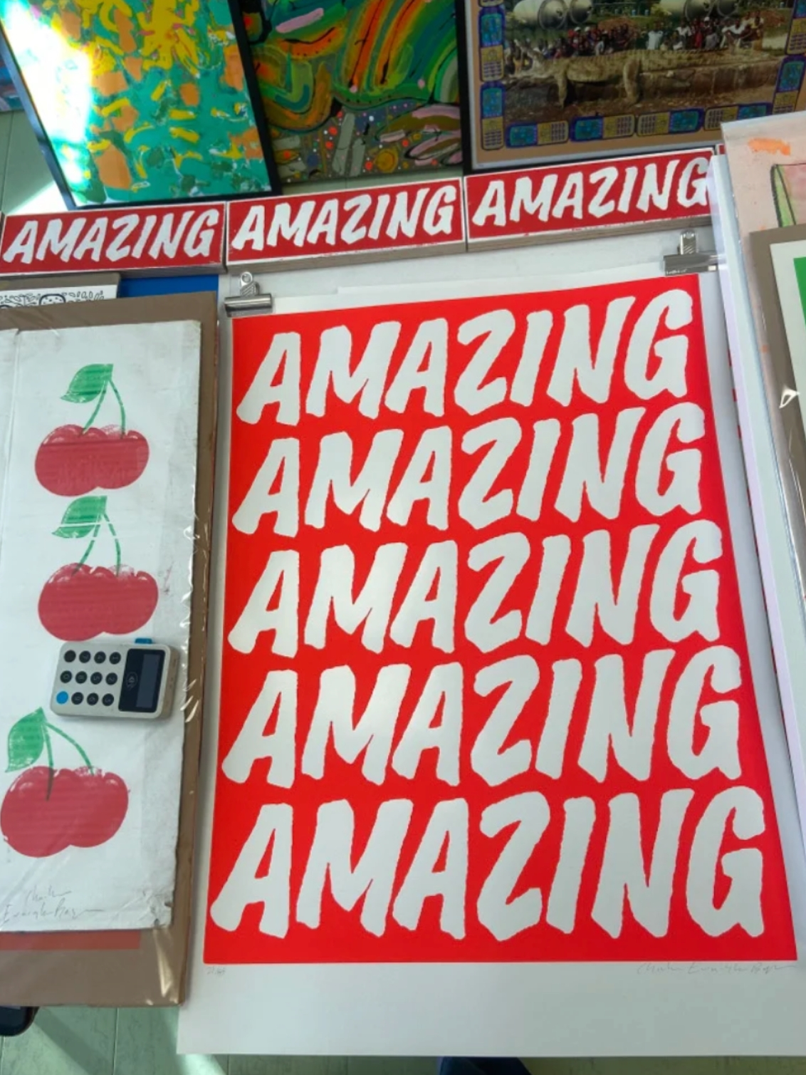 Fluoro Amazing Print. A vibrant red background with AMAZING written five times.