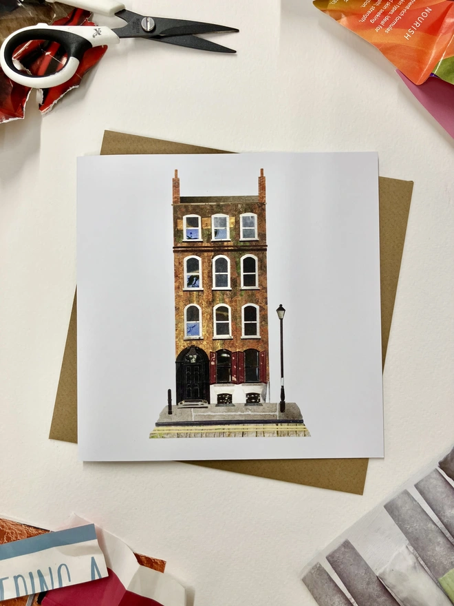 Greetings Card with a collaged illustration of a Spitalfields townhouse with an envelope on a white background with collage materials.