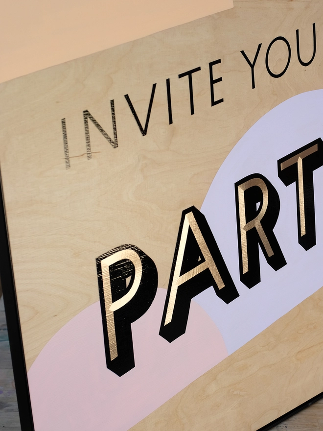 Close up of handpainted invite to party sign. 