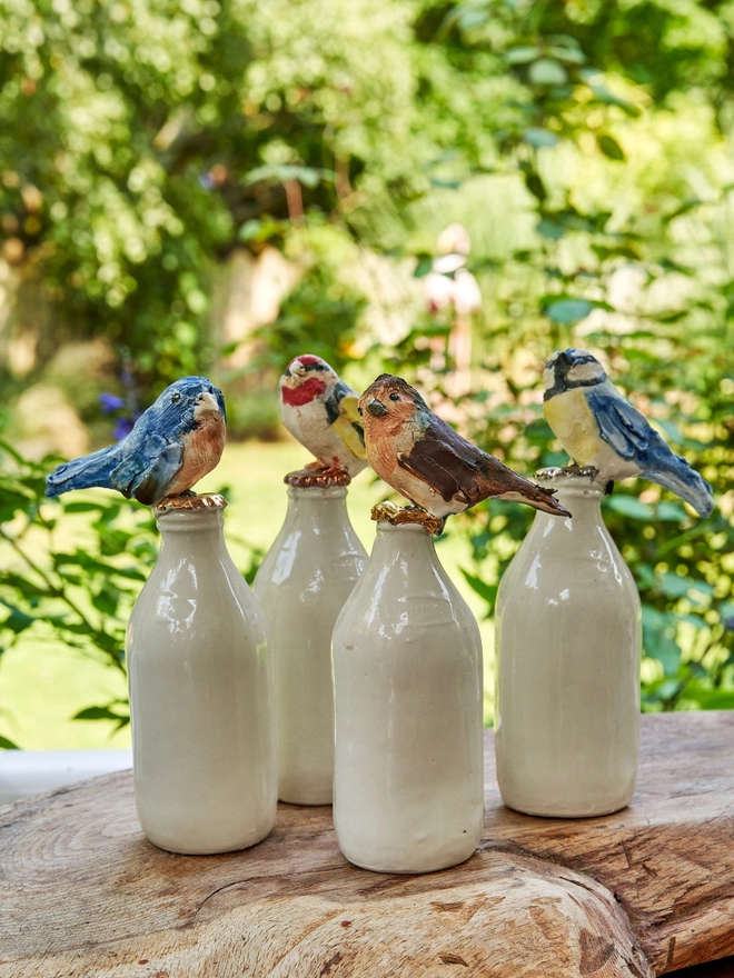 Large milk bottle bird sculptures