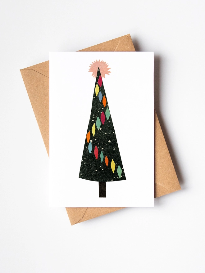A mid century style card featuring a pretty decorated Christmas tree.