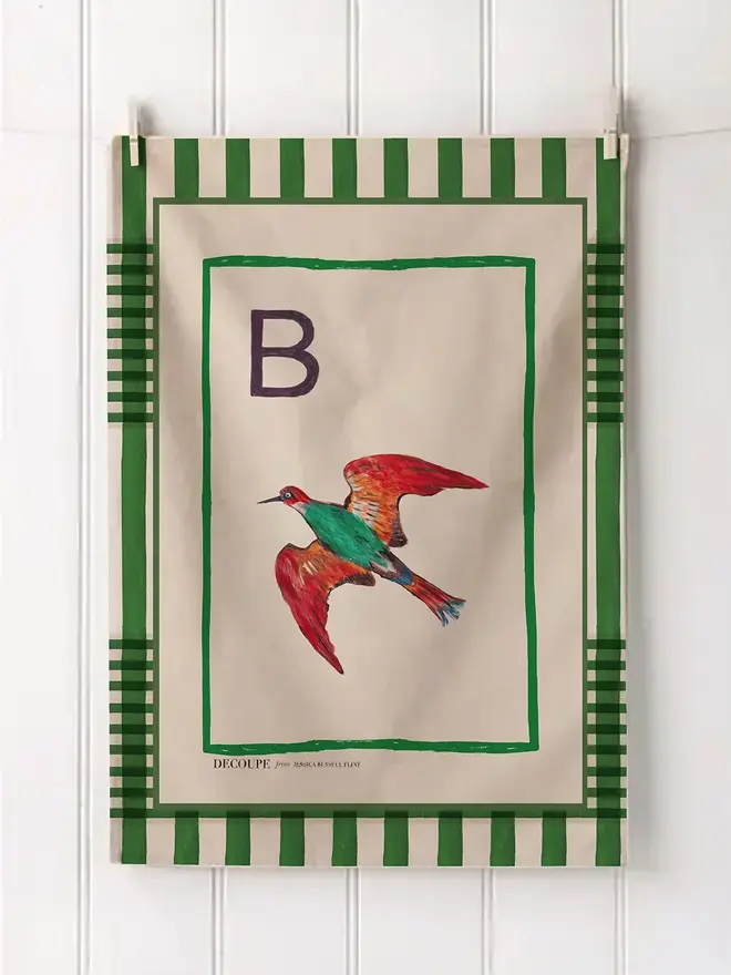 a-z alphabet tea towel. a tea towel with a bird print and the letter 'b' in the corner.