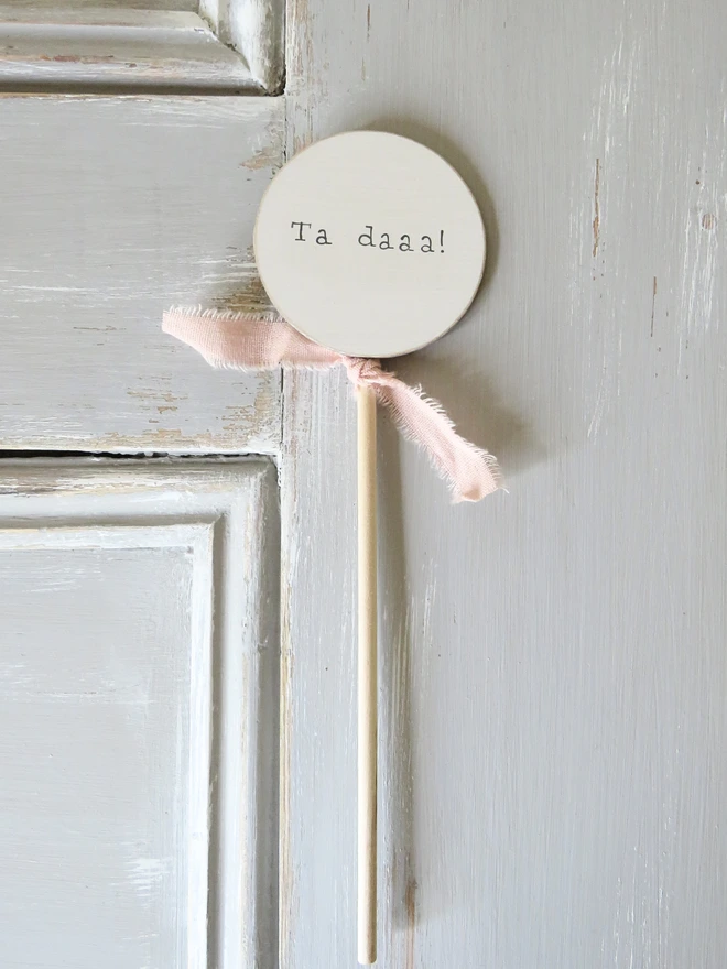 wooden circle shaped cake topper with hand painted message and custom ribbon