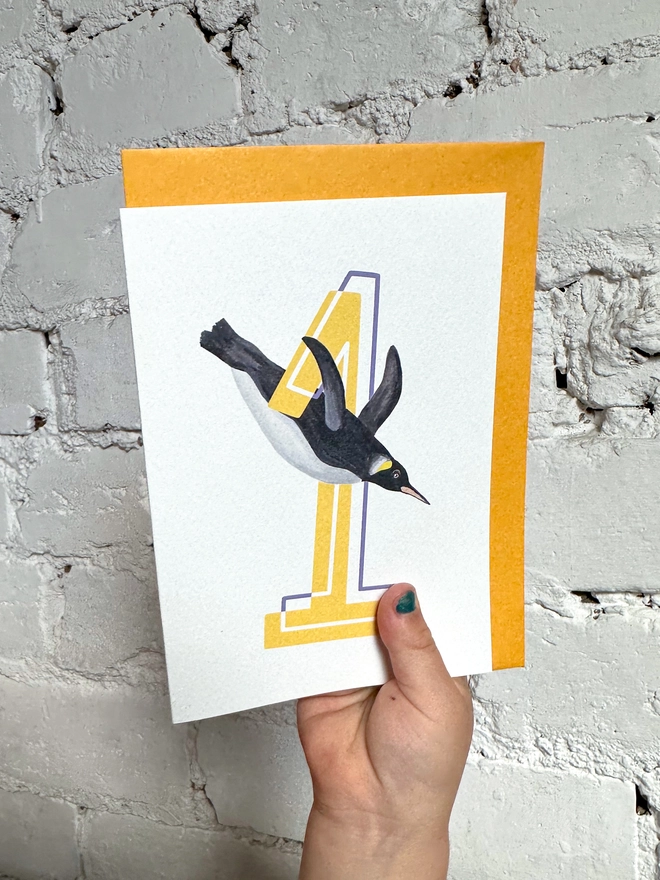 a white card with a big yellow number 1 and illustrated penguin with a bright yellow envelope