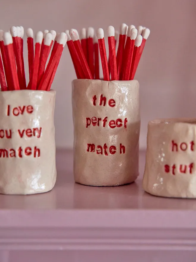three ceramic match holders 
