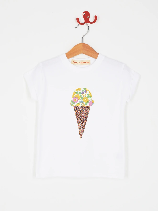  a white t-shirt with a floral ice cream sewn on the front
