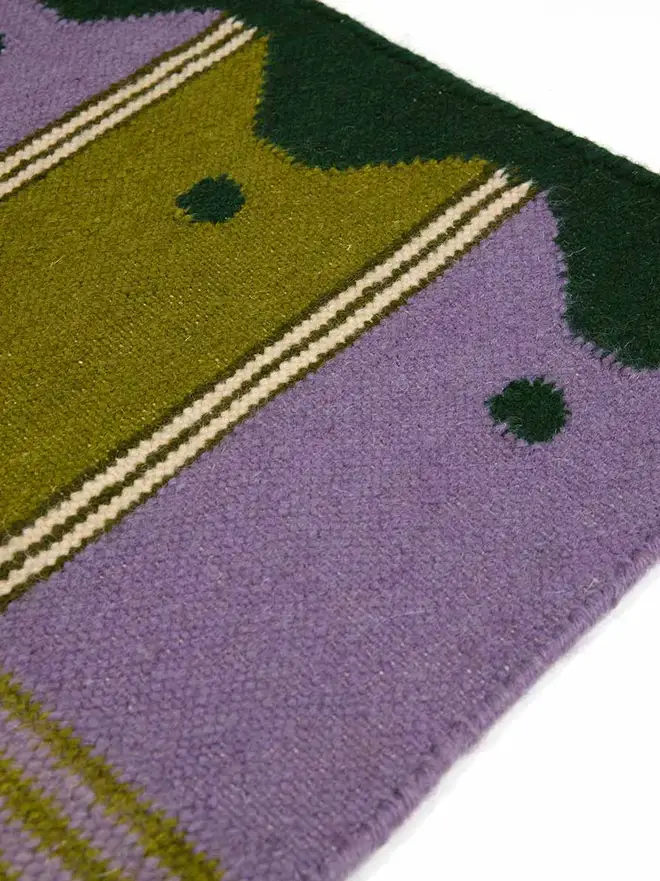 Ladder Flatweave Runner Rug, a colourful rug sitting on a white surface. 