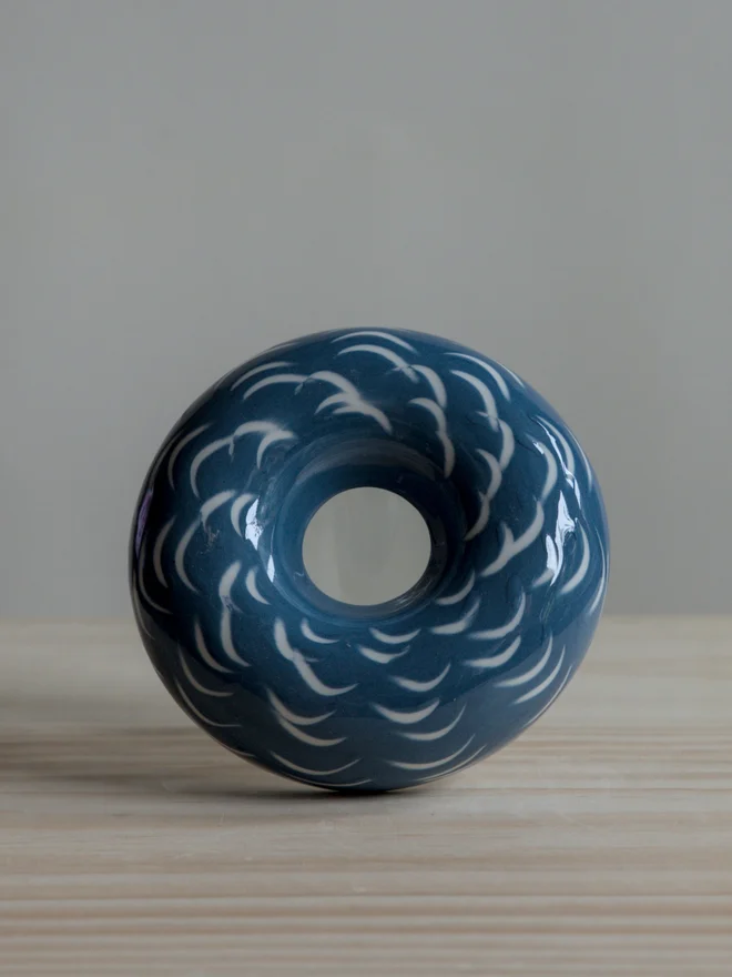 Handmade porcelain avocado planter with carved blue pattern, designed to hold an avocado seed for sprouting