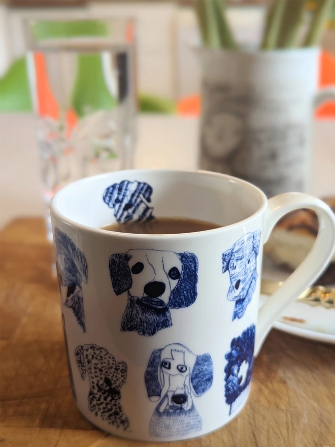 close up photo of blue dogs charity fine bone china dog gift mug featuring blue dog illustrations