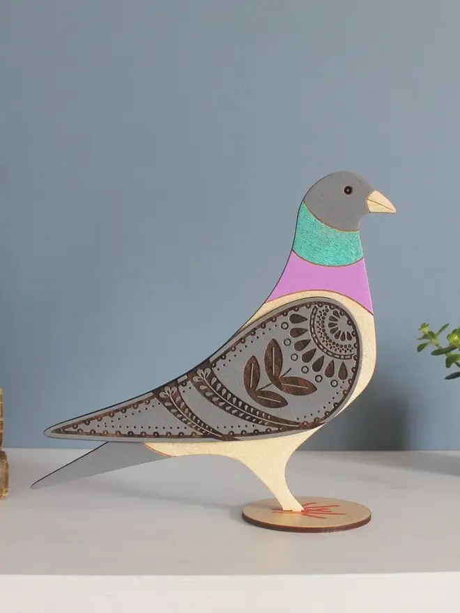 Standing Wooden Pigeon, wooden bird decoration standing on a platform. 