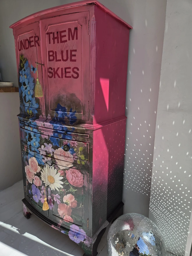 Painted vintage wooden cabinet with pink, blue and floral decoration