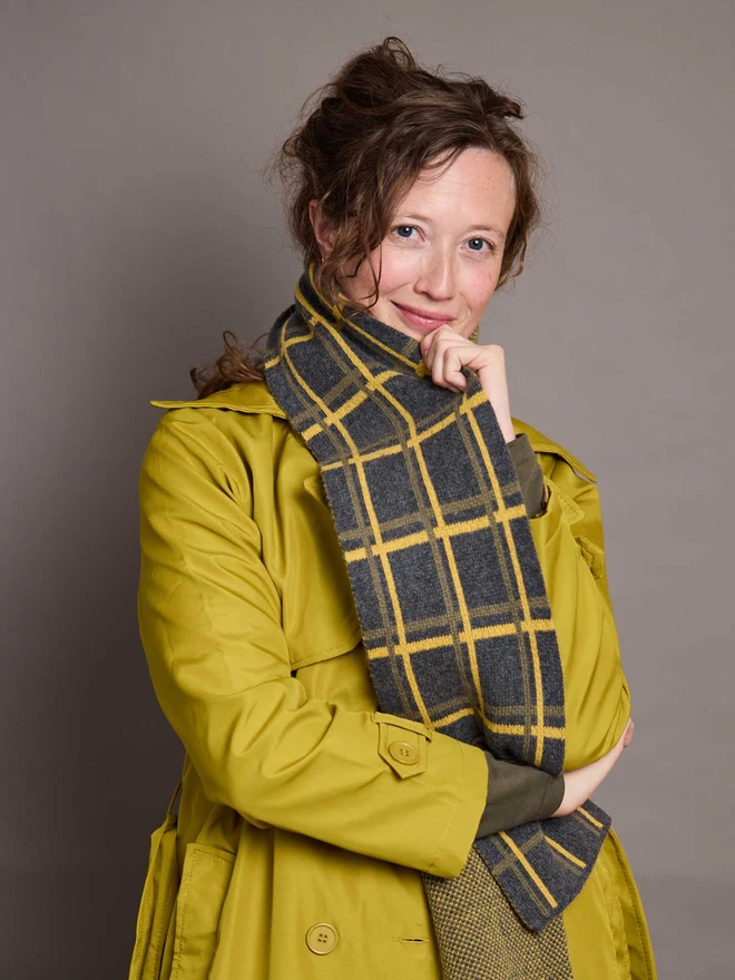Grey And Yellow Patterned Wool Scarf Modelled By A Woman In A Yellow Coat