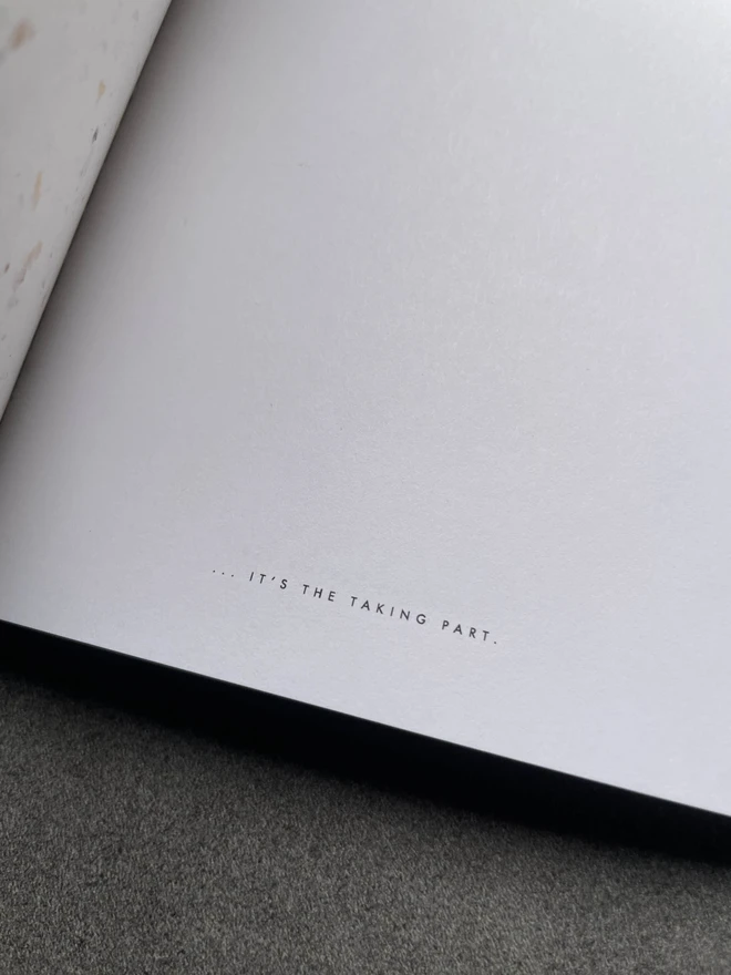 a close up of a notebook page. At the bottom of the page it says "it's the taking part"