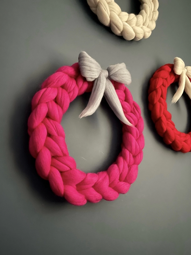 Bright pink woolly wreath with grey bow