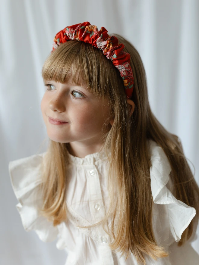 Girl wearing Liberty Red ruffled Hairband Alice Band