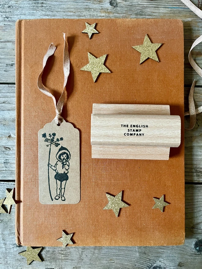 pixie traditiona wooden stamp stamped on a kraft swing tag