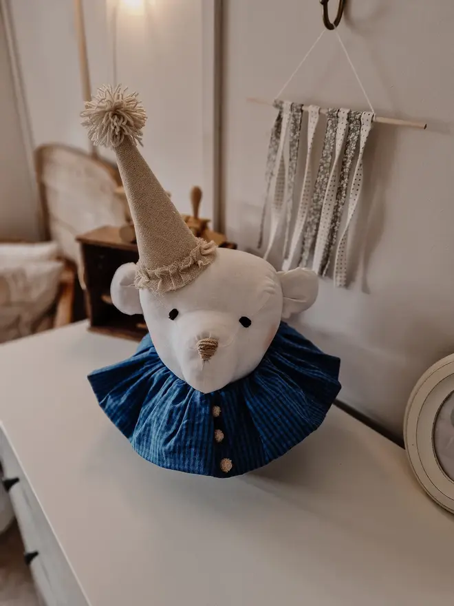 Bear Head Nursery Decoration, a bear decoration sitting against a wall in a child's decorated bedroom. 