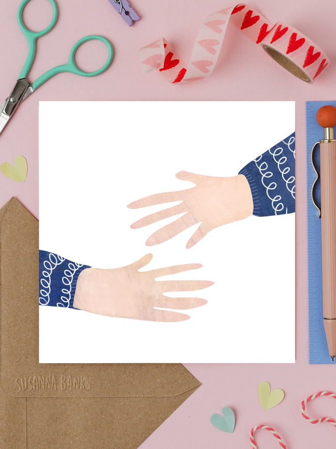 illustrated hug empathy card. card photographed on table with assorted crafting items.