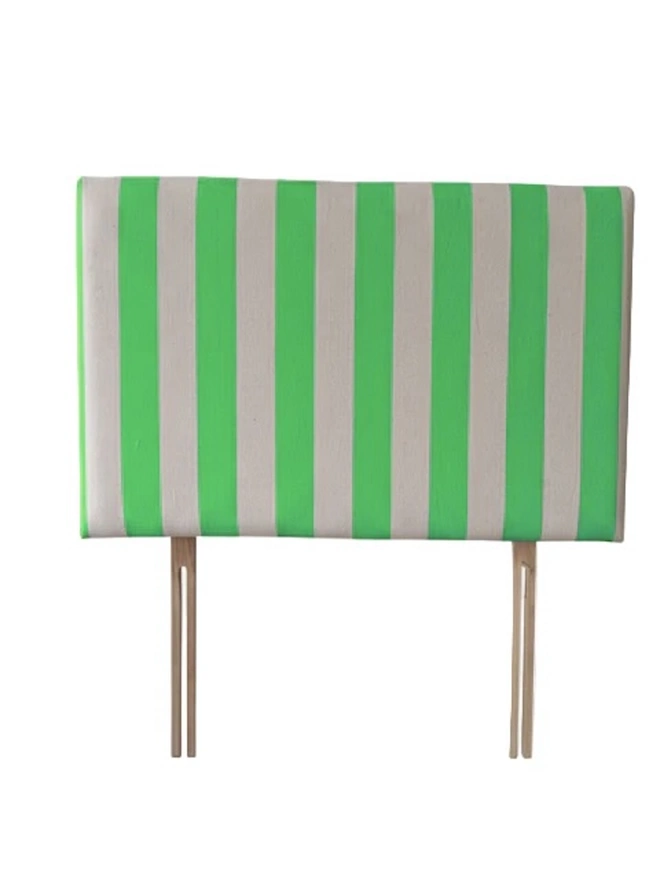 Hand Painted Upholstered Linen Headboard In Stripe Print, a neon green striped headboard sitting against a white background. 