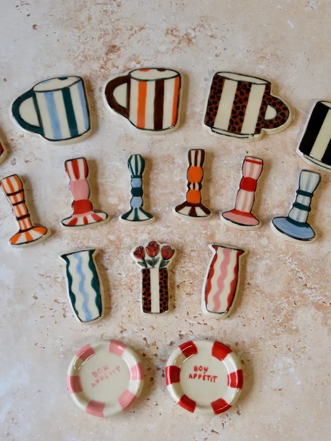 Handmade ceramic magnets — assorted designs including mugs, vases, plates, and candlesticks