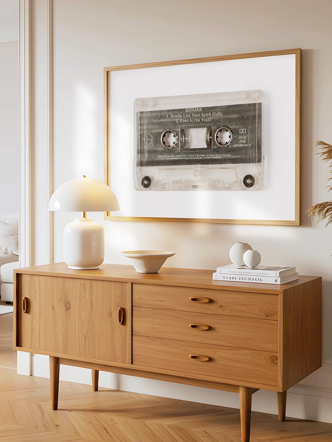 Nirvana 'Smells Like Teen Spirit cassette tape print. framed print hung up above wooden dresser.
