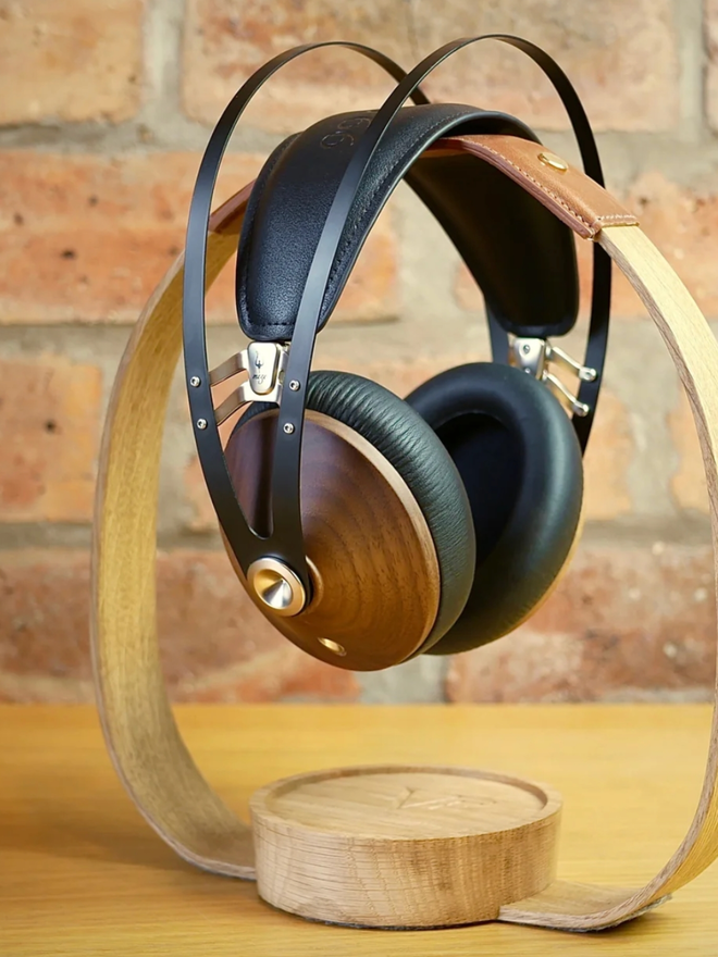 The Band Wooden Headphone Stand. A wooden headphone stand in Natural with Tan leather.