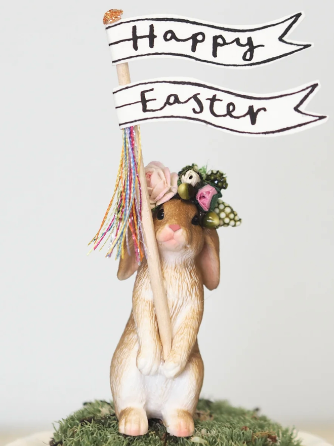 Standing Rabbit Happy Easter Cake Topper Decoration. A standing rabbit with a sign saying Happy Easter and a flower crown.