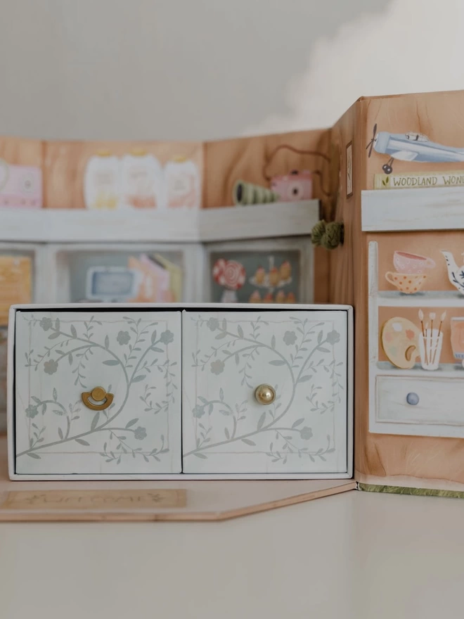 Two drawers containing a music box, storybook and a beautiful set of accessories for the Woodland Wonders play set.