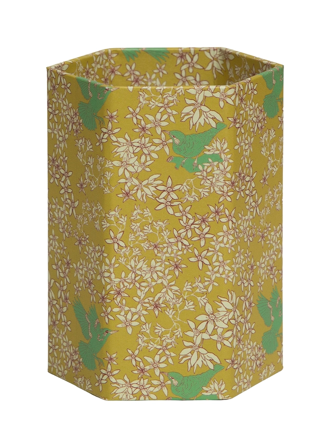 Corali Hexagonal Brush Pot, a colourful patterned pencil pot sitting on a white surface against a plain backdrop.