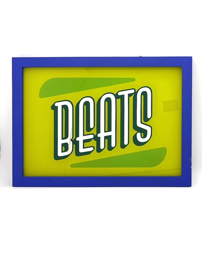 'Breaks, Beats,Funk, Soul' Gold Leaf Glass Artwork, against a white wall. 