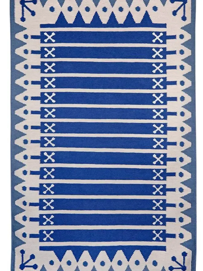 blue Darjeeling Flatweave Rug, a colourful rug on a plain surface. 