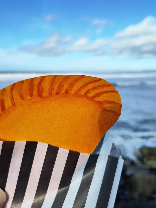 a close up of the hand-painted pasty, showing the detail in the golden crust